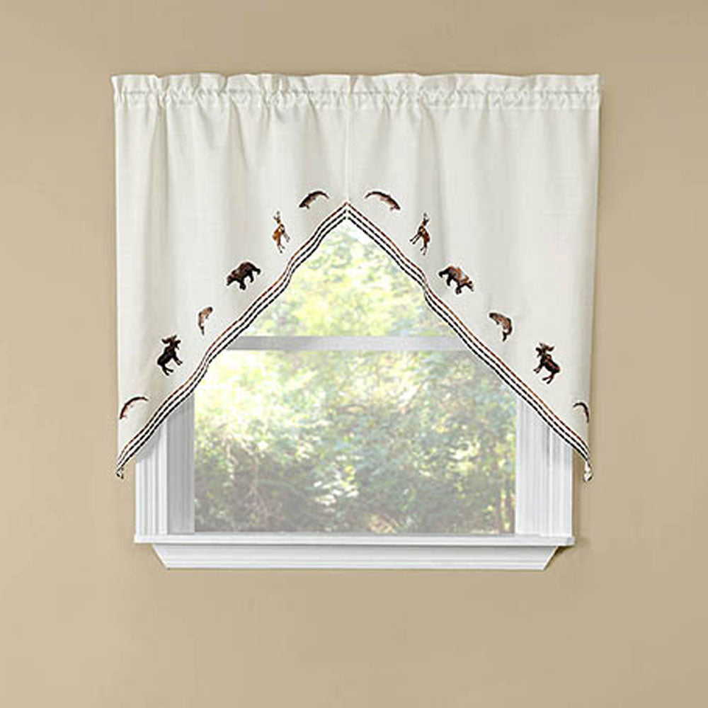 Lodge Embroidered Kitchen Swags hanging on a curtain rod