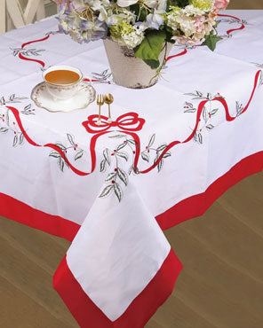 White Euro Seasonal Bows Fabric Tablecloth over a table
